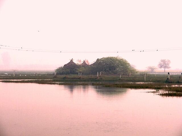 The water surrounding the shram at Bankhandi appears to kiss Arun dev as it reflects his rosyness.