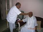 Surinder bhaisab putting color on Baba