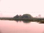 The water surrounding the shram at Bankhandi appears to kiss Arun dev as it reflects his rosyness.