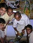 Baba mixing mahaprasad in the prasadam bucket
